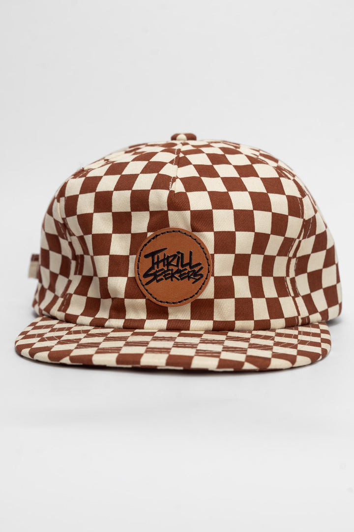Checkered cap with rusty clay and off-white on a white background