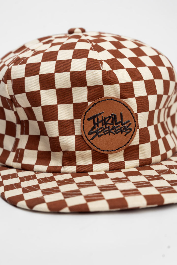 Checkered cap with rusty clay and off-white on a white background