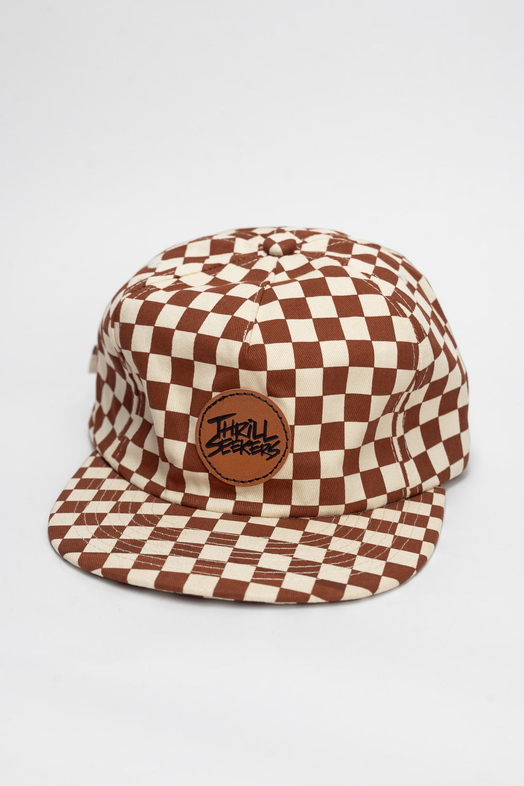 Checkered cap with rusty clay and off-white on a white background
