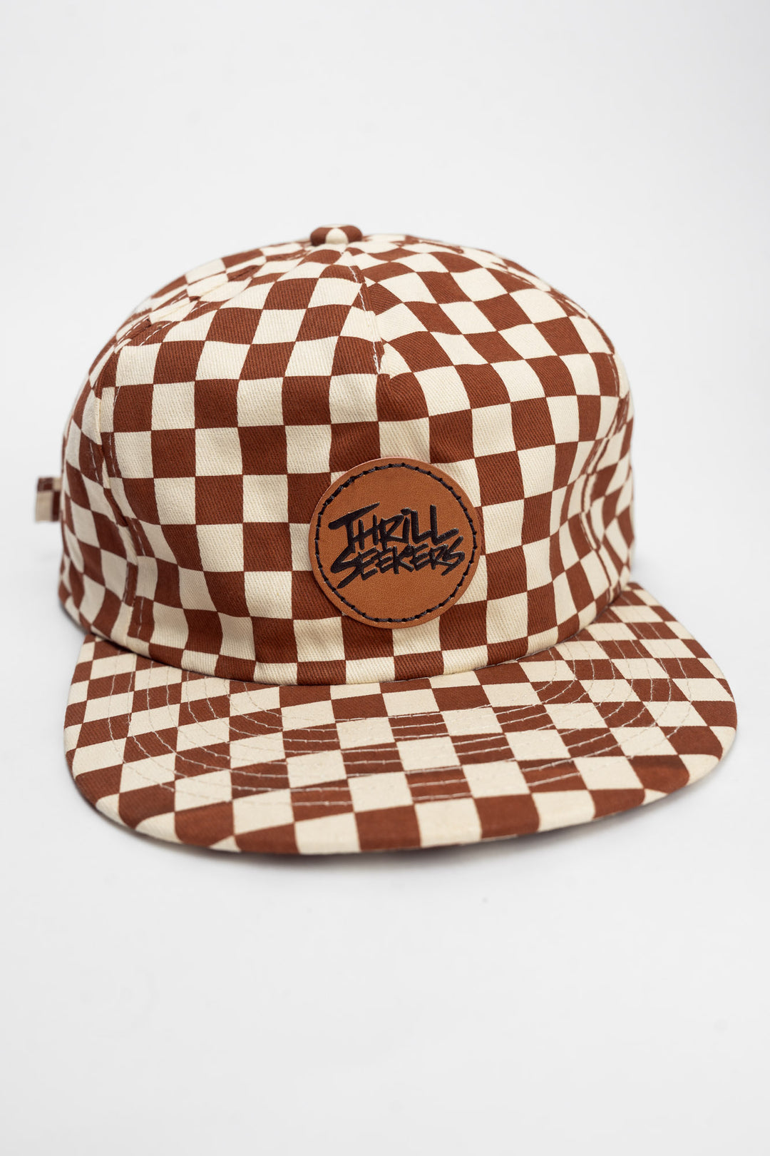 Checkered cap with rusty clay and off-white on a white background