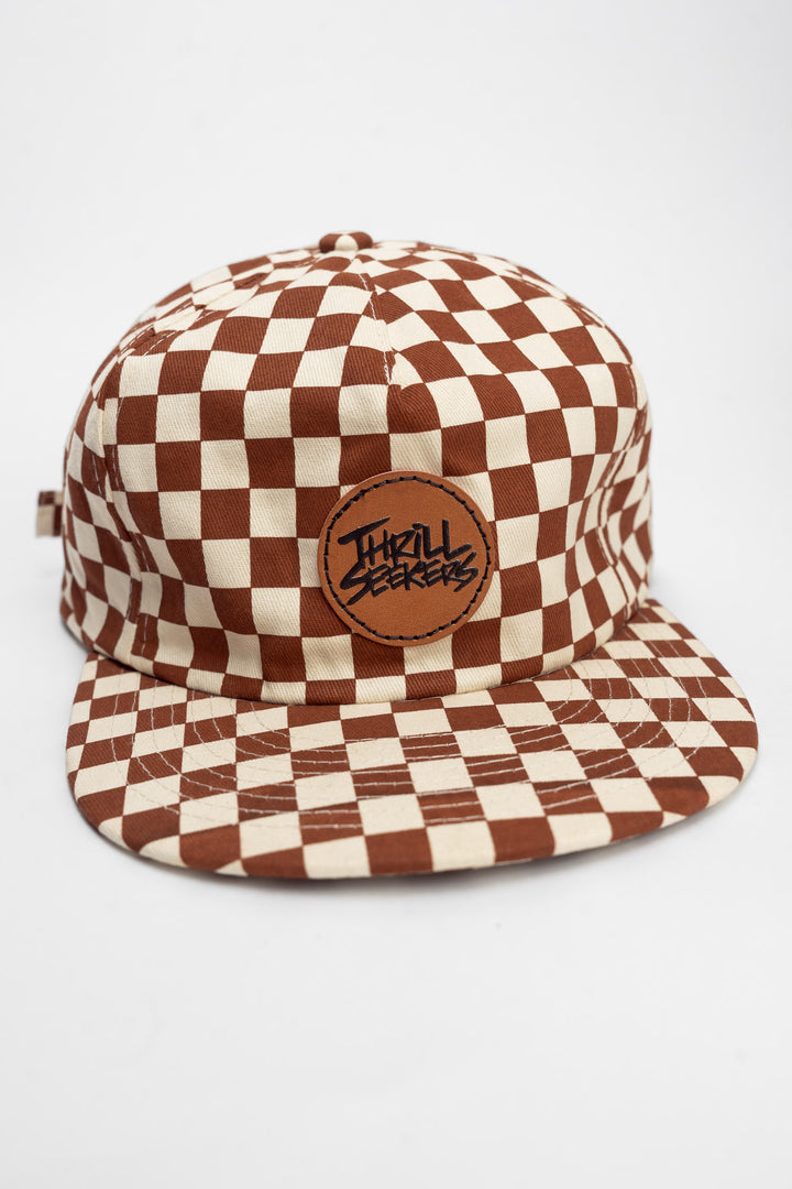 Checkered cap with rusty clay and off-white on a white background