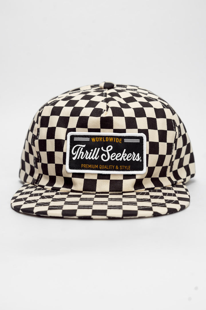 Checkered cap with 'Thrill Seekers' logo on a white background