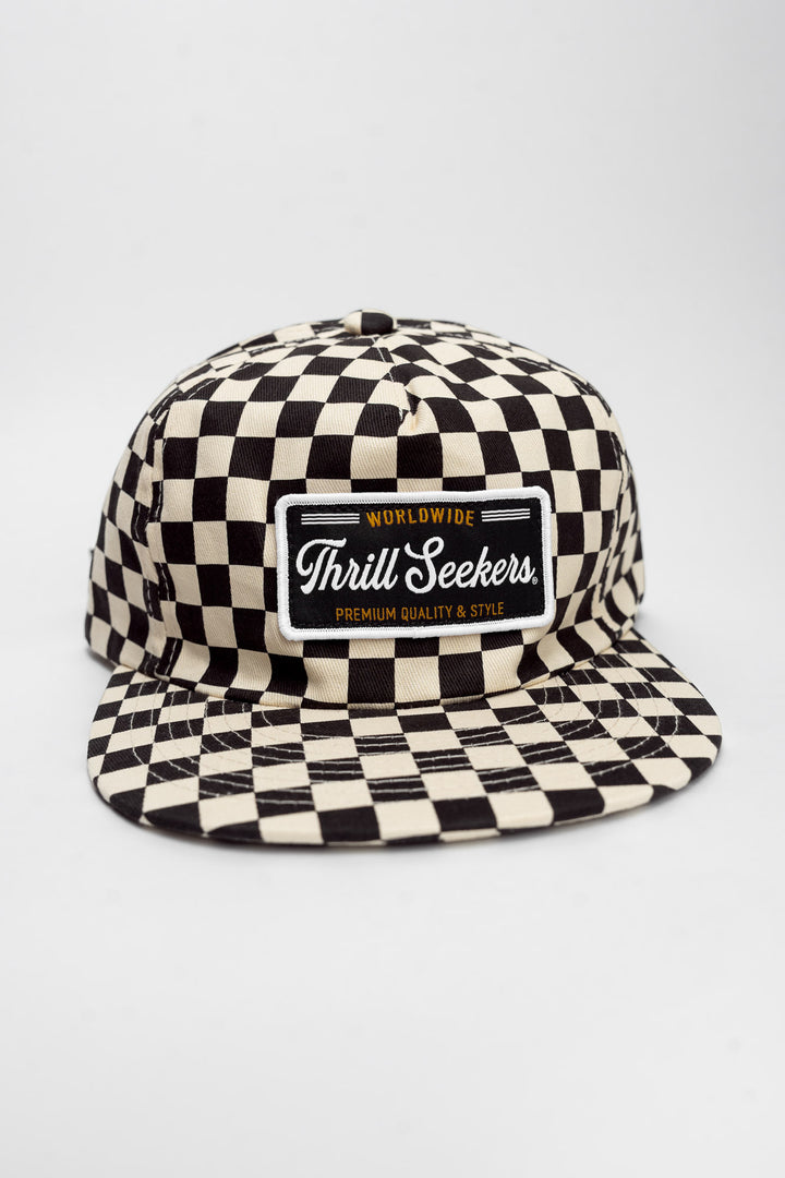 Checkered cap with 'Thrill Seekers' logo on a white background