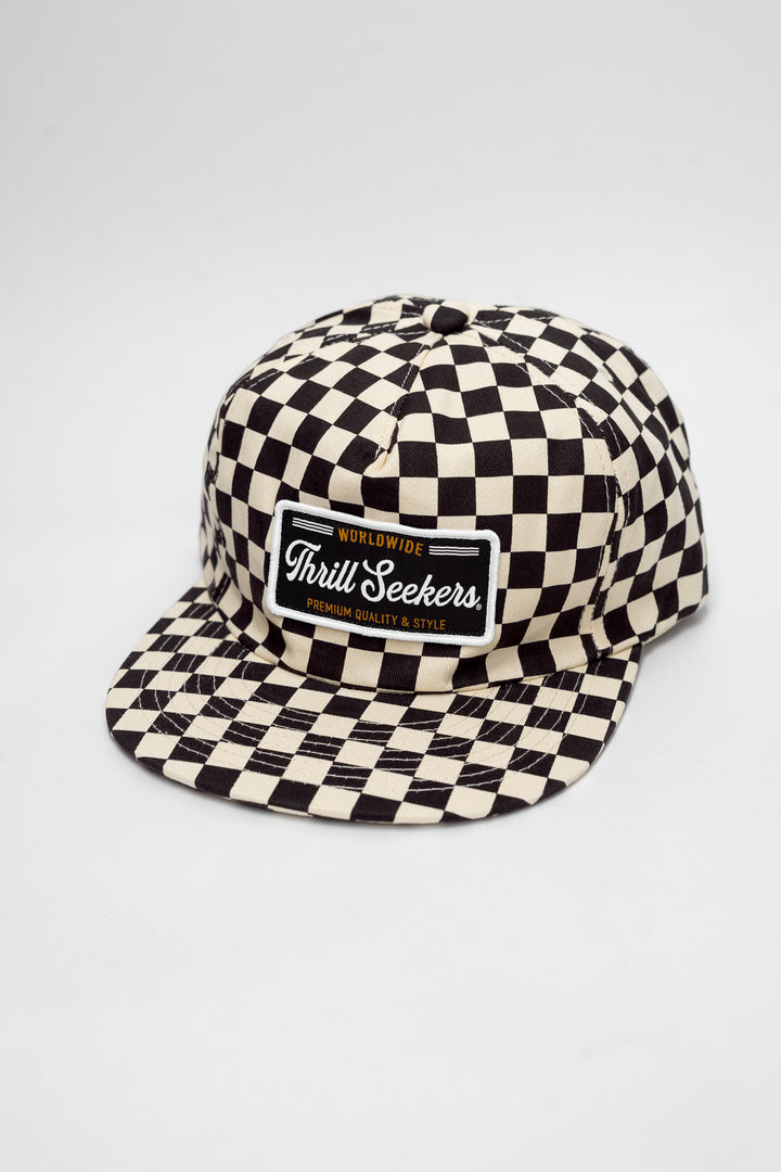 Checkered cap with 'Thrill Seekers' logo on a white background