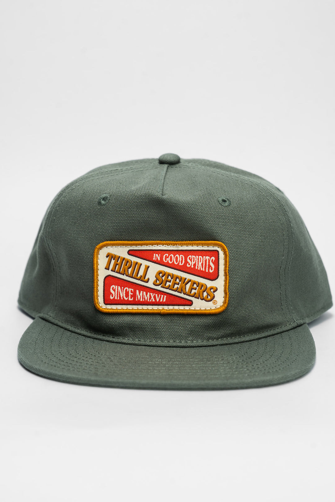 Green cap with a 'Thrill Seekers' patch on a white background