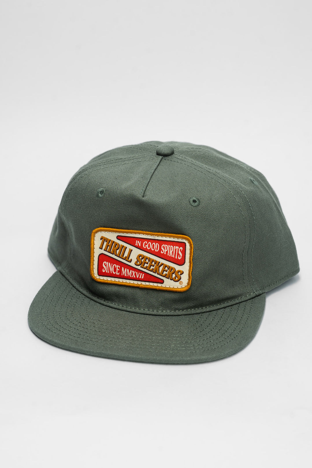Green cap with a 'Thrill Seekers' patch on a white background
