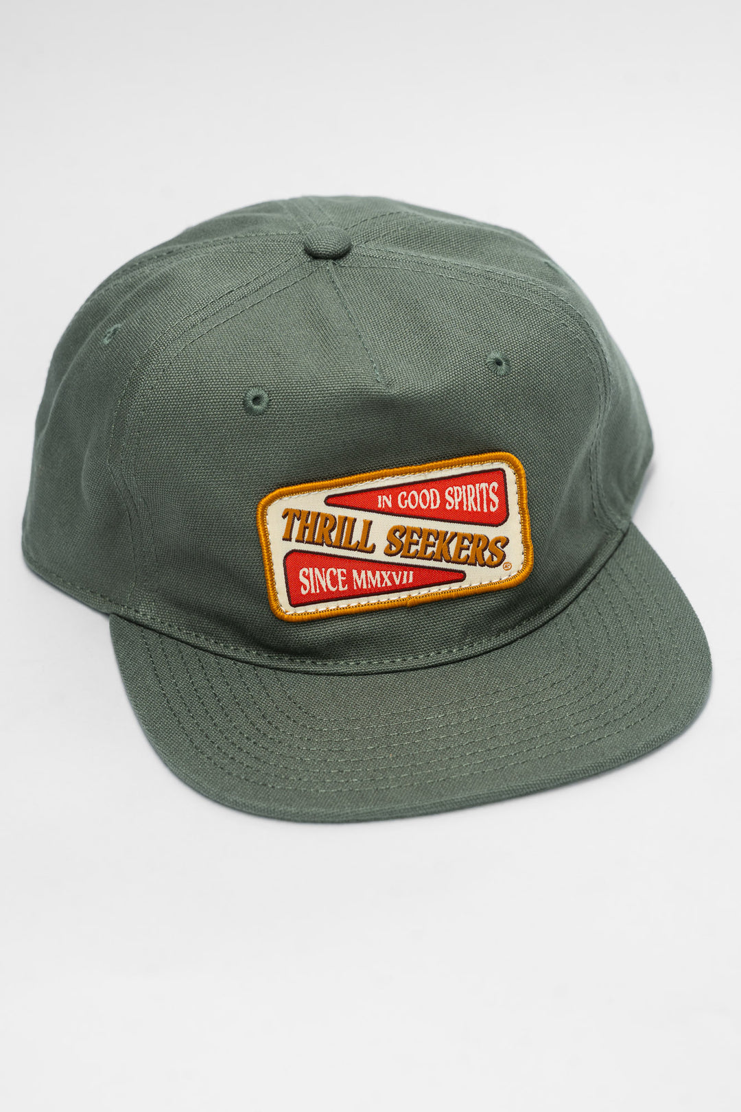 Green cap with a 'Thrill Seekers' patch on a white background
