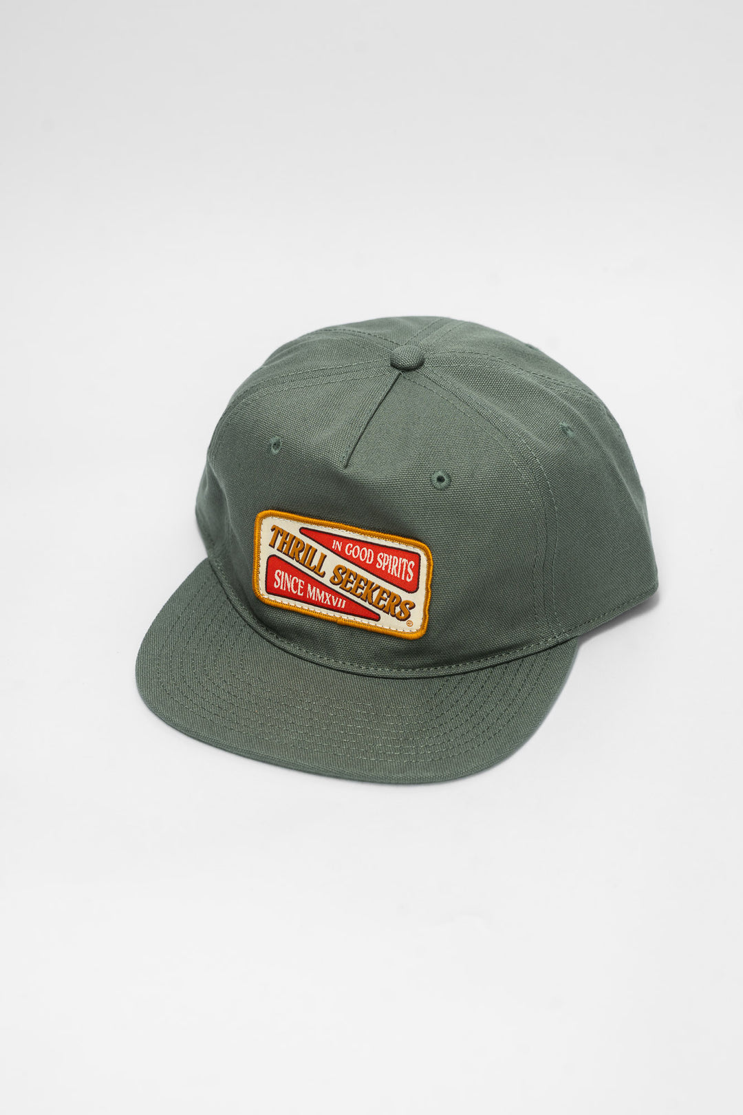 Green cap with a 'Thrill Seekers' patch on a white background