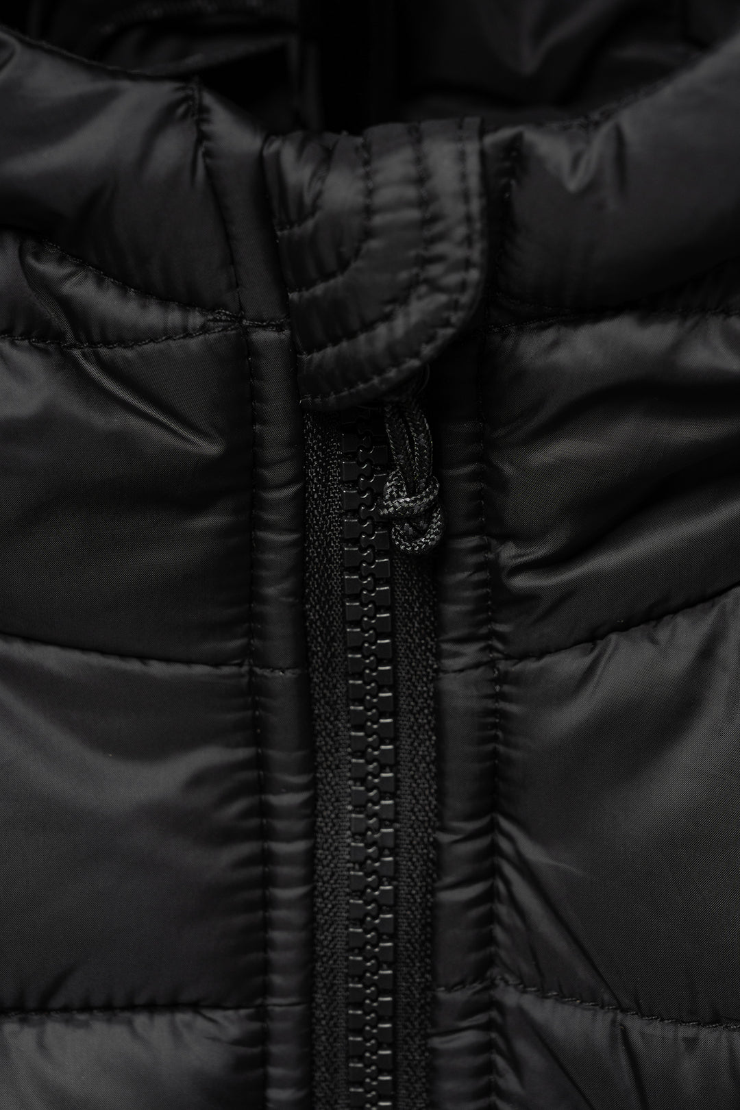 Close-up of a black puffer jacket zipper