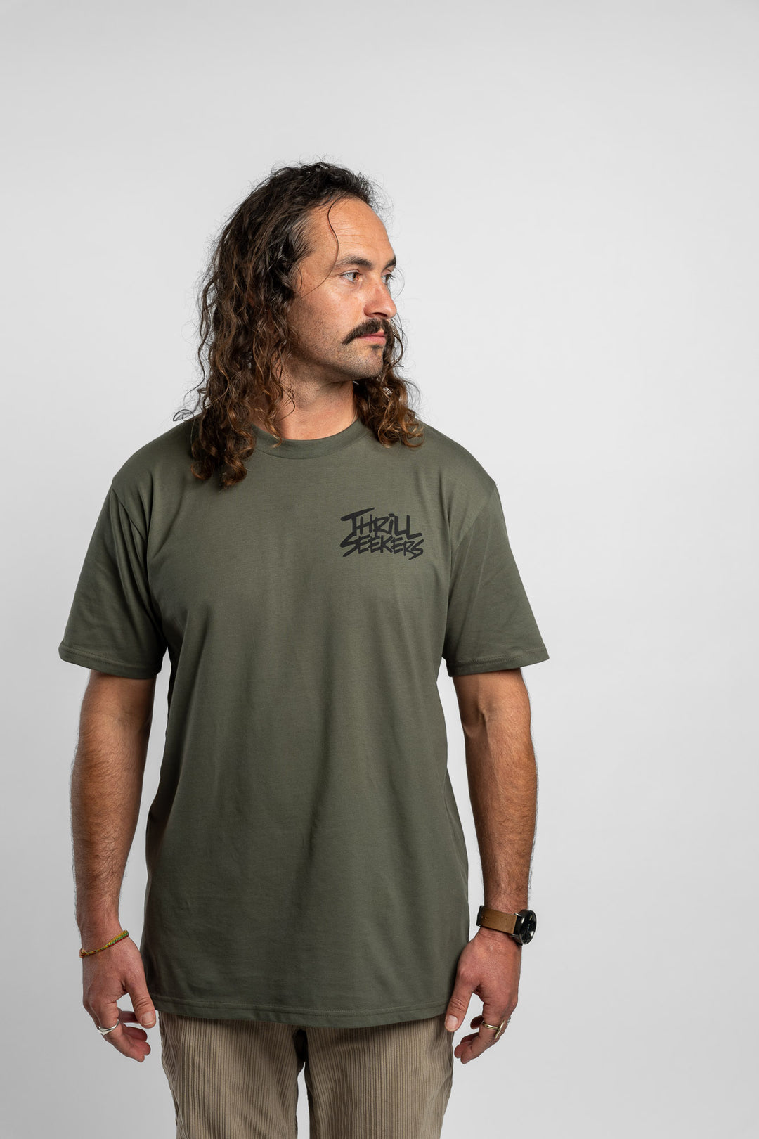 Person wearing a cypress tee with 'Thrill Seekers' logo in black