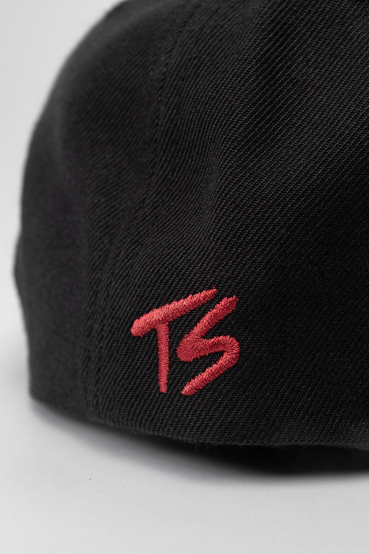 Black snapback hat with 'Thrill Seekers' logo in cardinal red
