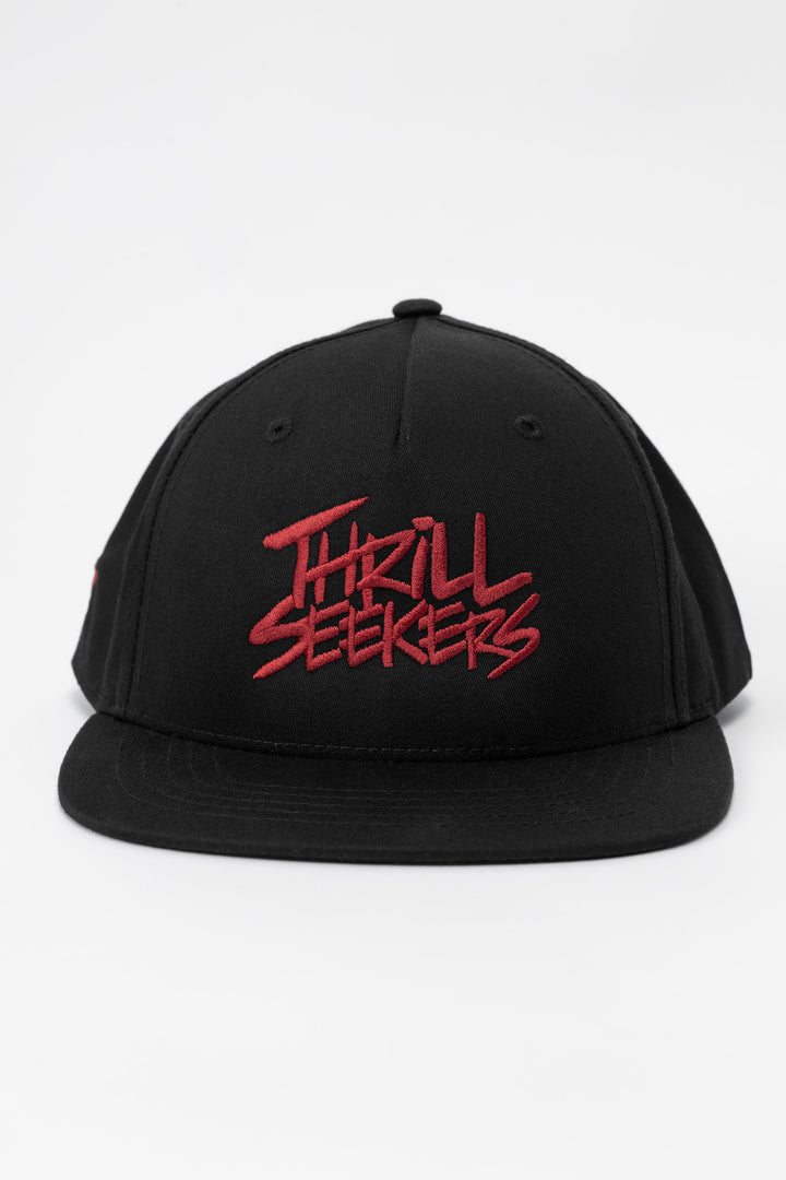Black cap with cardinal red 'Thrill Seekers' text on a white background
