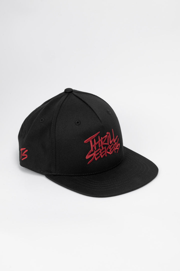 Black cap with cardinal red 'Thrill Seekers' text on a white background