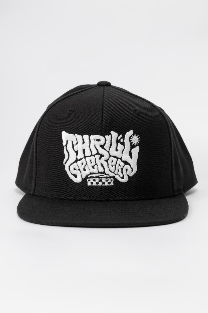 Kids black cap with 'Thrill Seekers' white logo on a white background