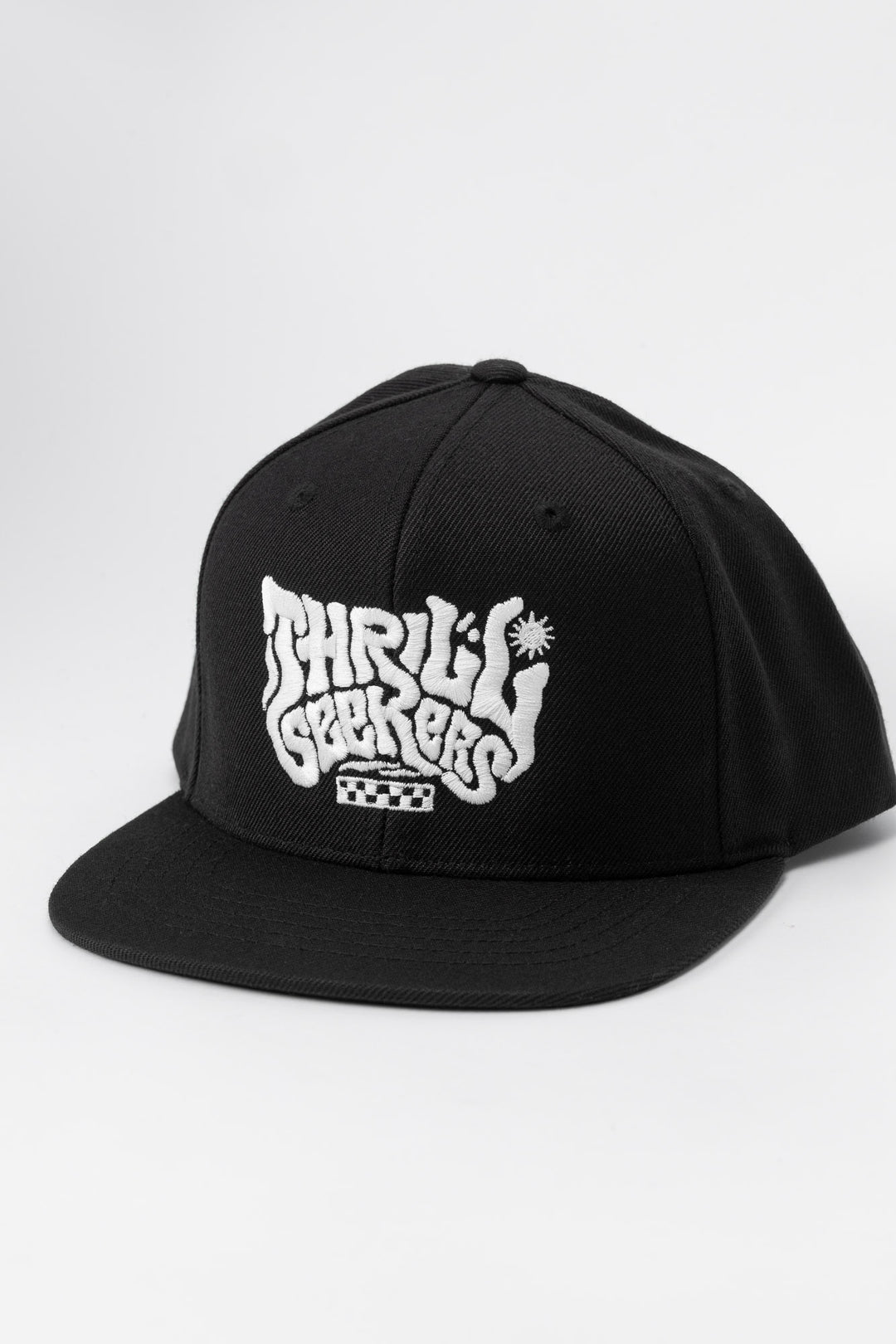 Kids black cap with 'Thrill Seekers' white logo on a white background