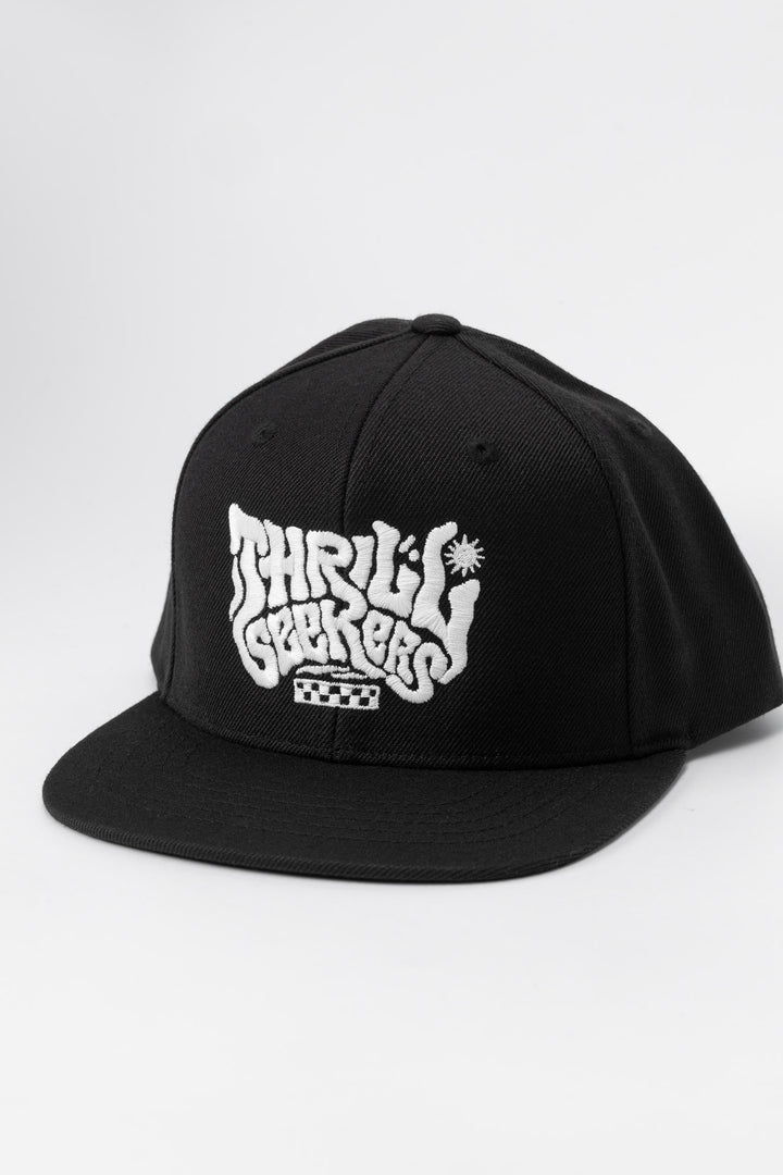 Kids black cap with 'Thrill Seekers' white logo on a white background