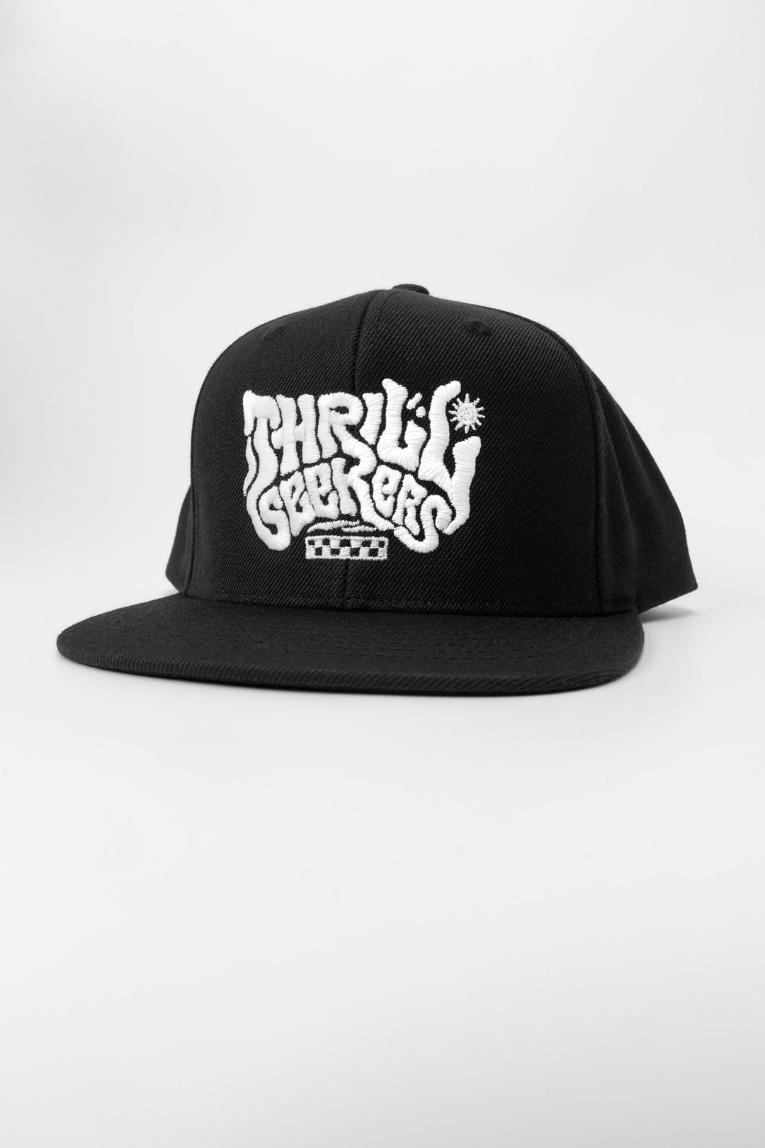 Kids black cap with 'Thrill Seekers' white logo on a white background