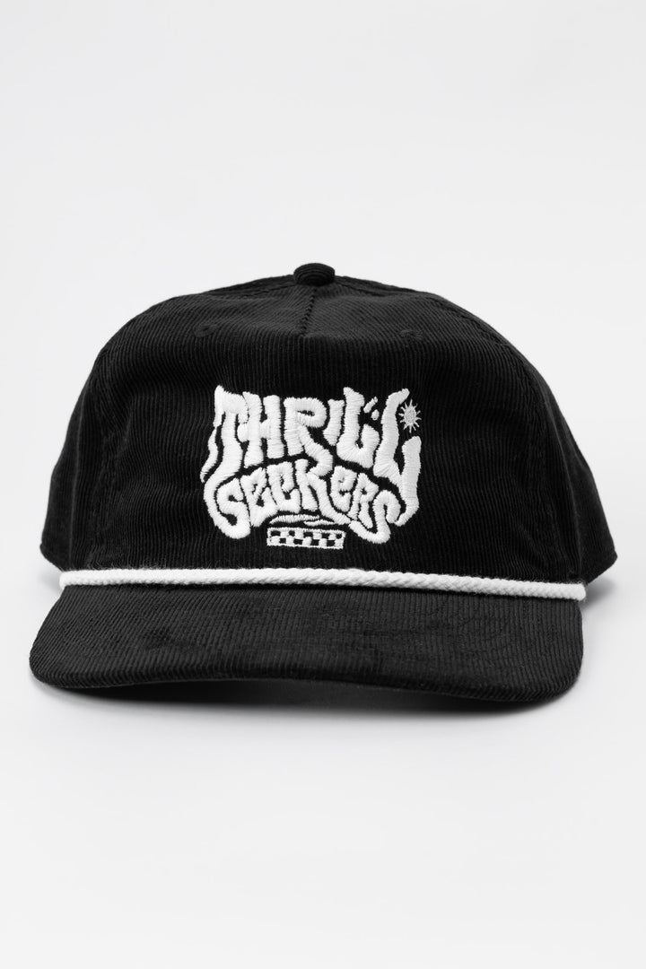 Black cap corduroy with 'Thrill Seekers' smokin' white logo on a white background