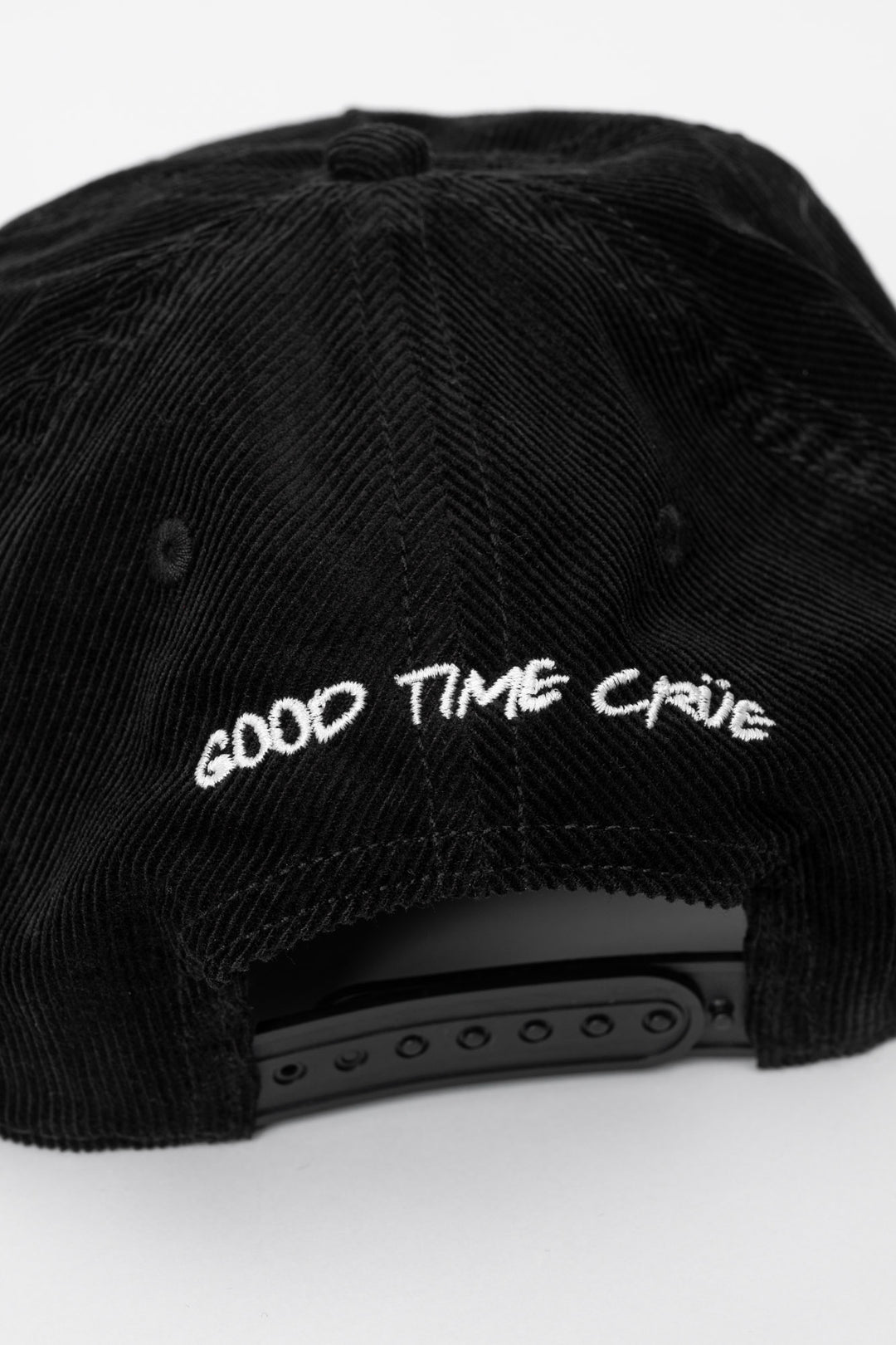 Back of a black cap corduroy with 'Good Time Crue' on a white background