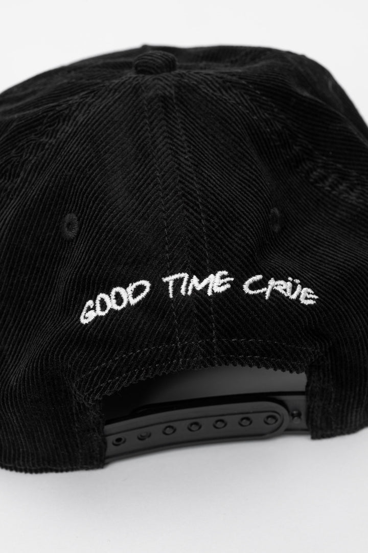 Back of a black cap corduroy with 'Good Time Crue' on a white background