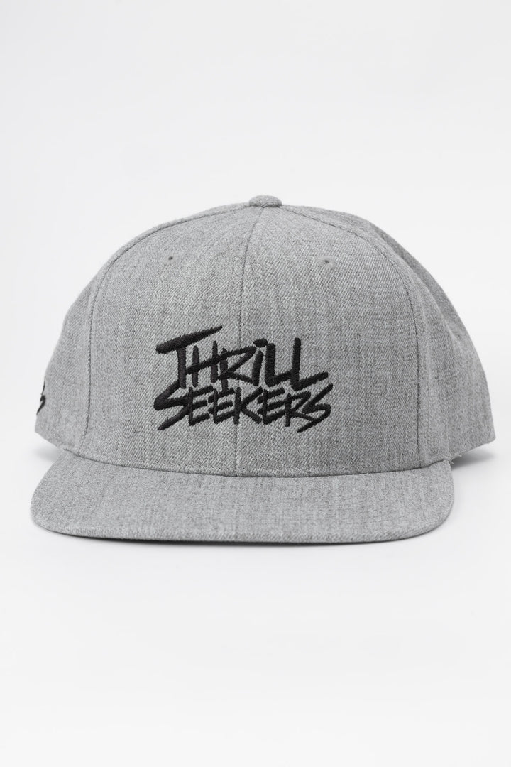 Grey snapback hat with 'Thrill Seekers' logo in black