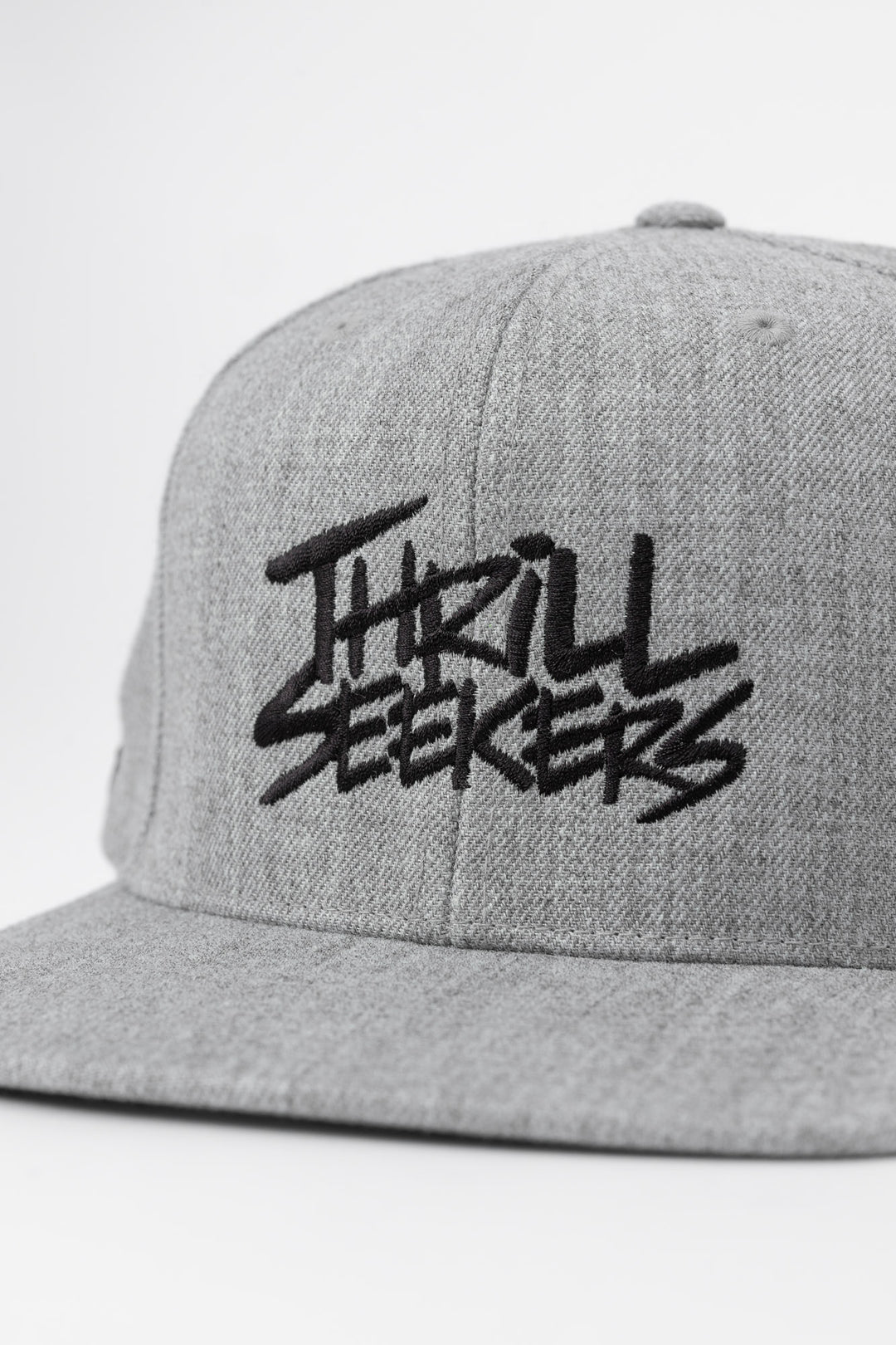 Grey snapback hat with 'Thrill Seekers' logo in black