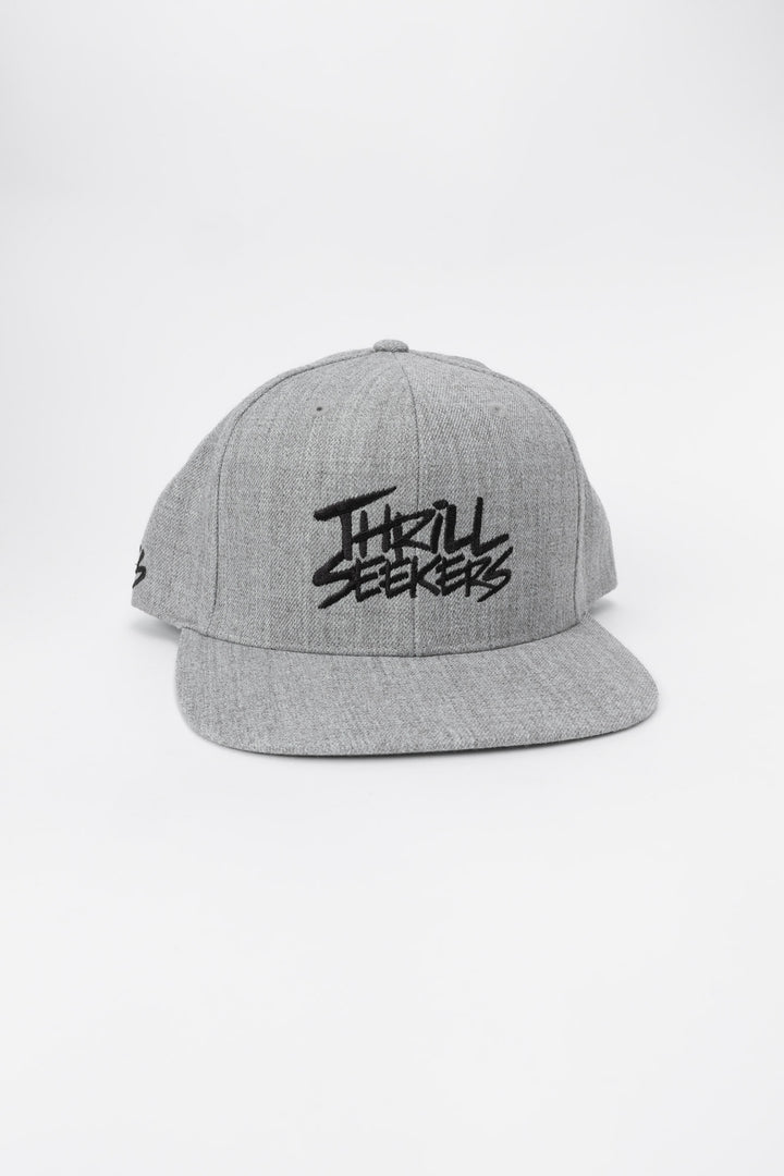Grey snapback hat with 'Thrill Seekers' logo in black