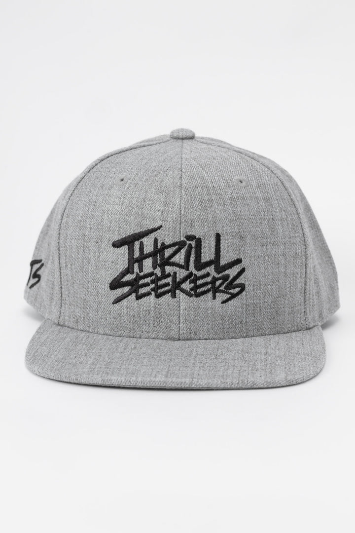 Grey cap with black 'Thrill Seekers' logo on a white background