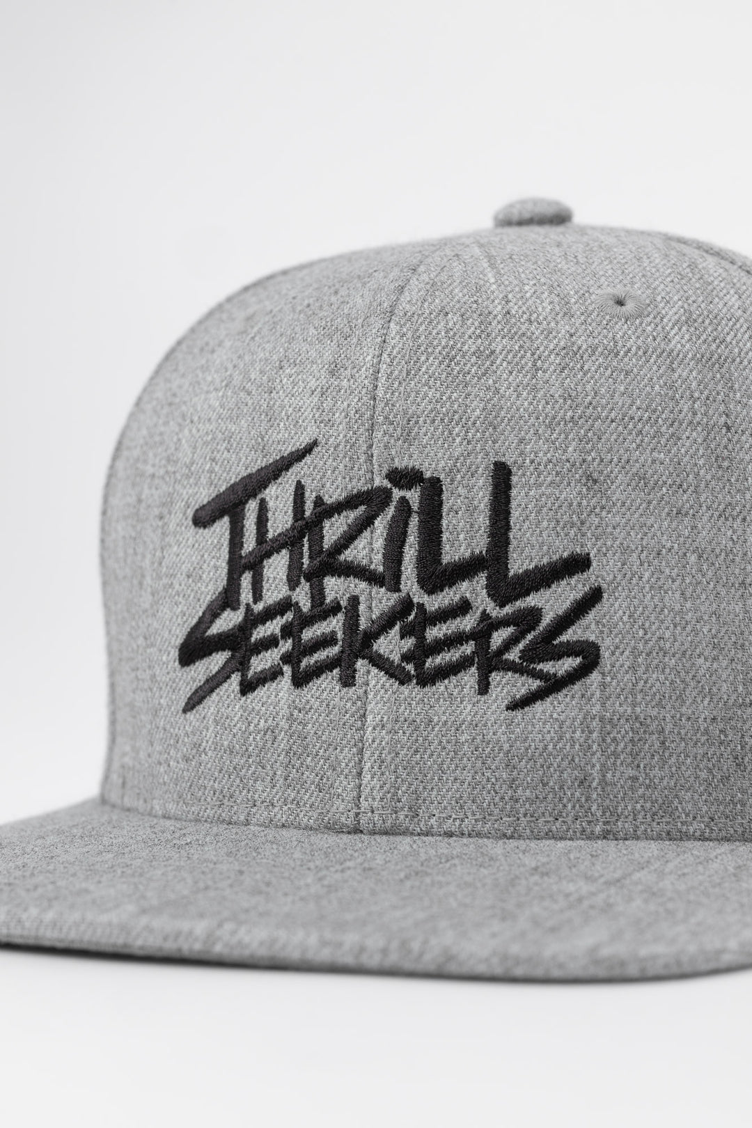 Grey cap with black 'Thrill Seekers' logo on a white background