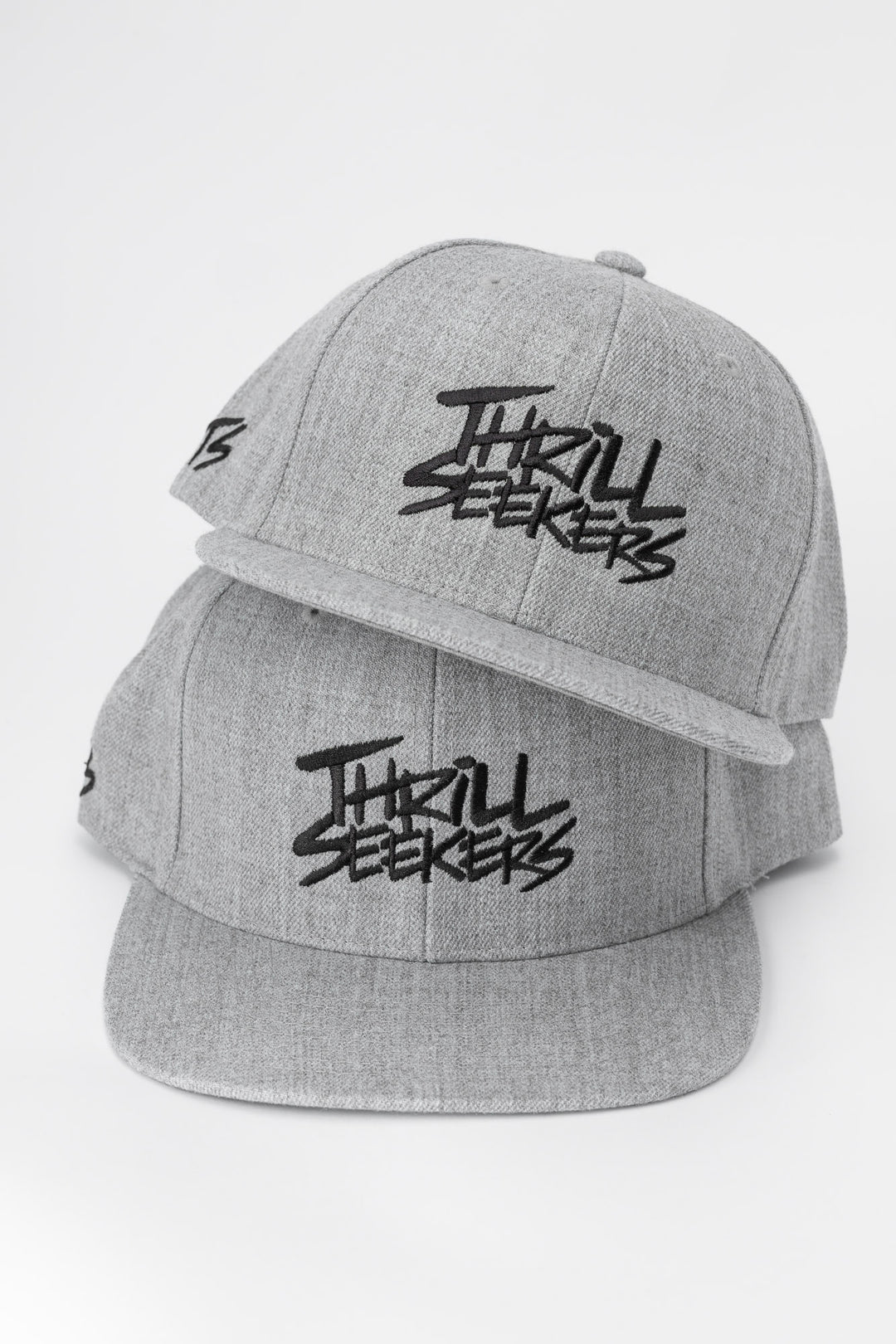 Grey cap with black 'Thrill Seekers' logo on a white background