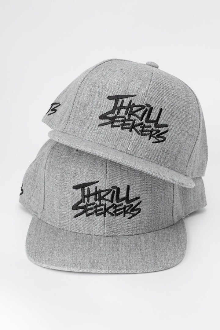 Grey cap with black 'Thrill Seekers' logo on a white background