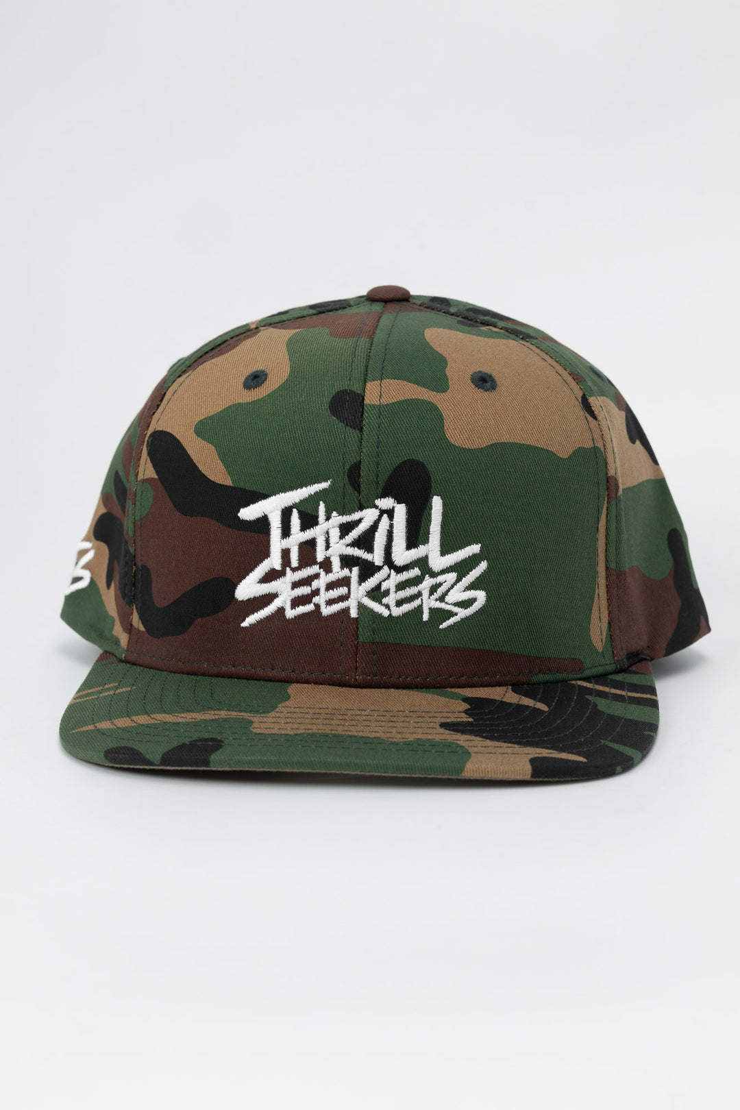 Camo snapback hat with 'Thrill Seekers' logo in white