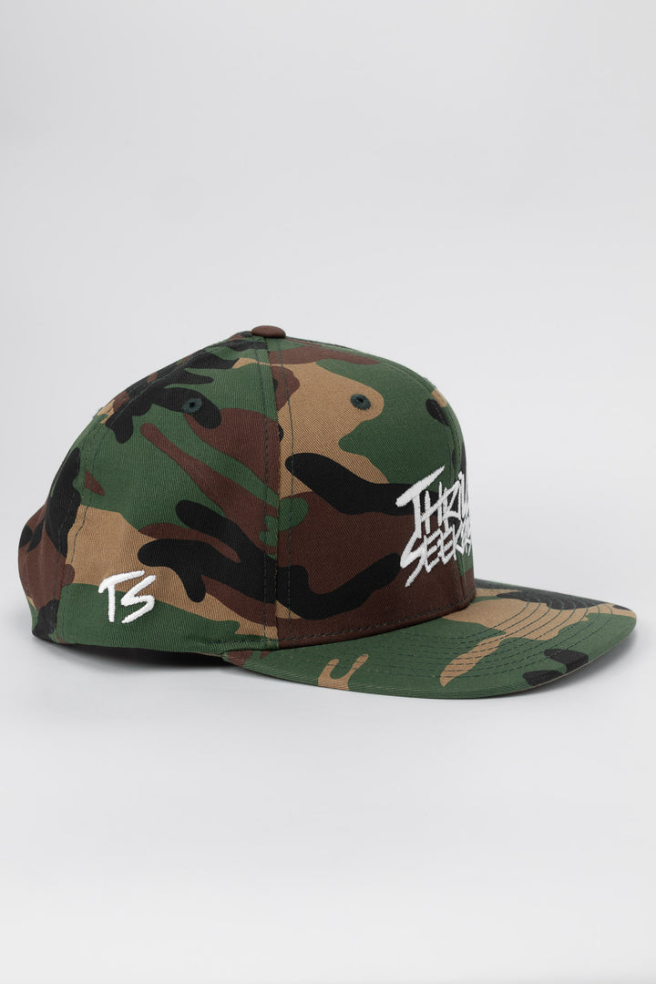 Camo snapback hat with 'Thrill Seekers' logo in white