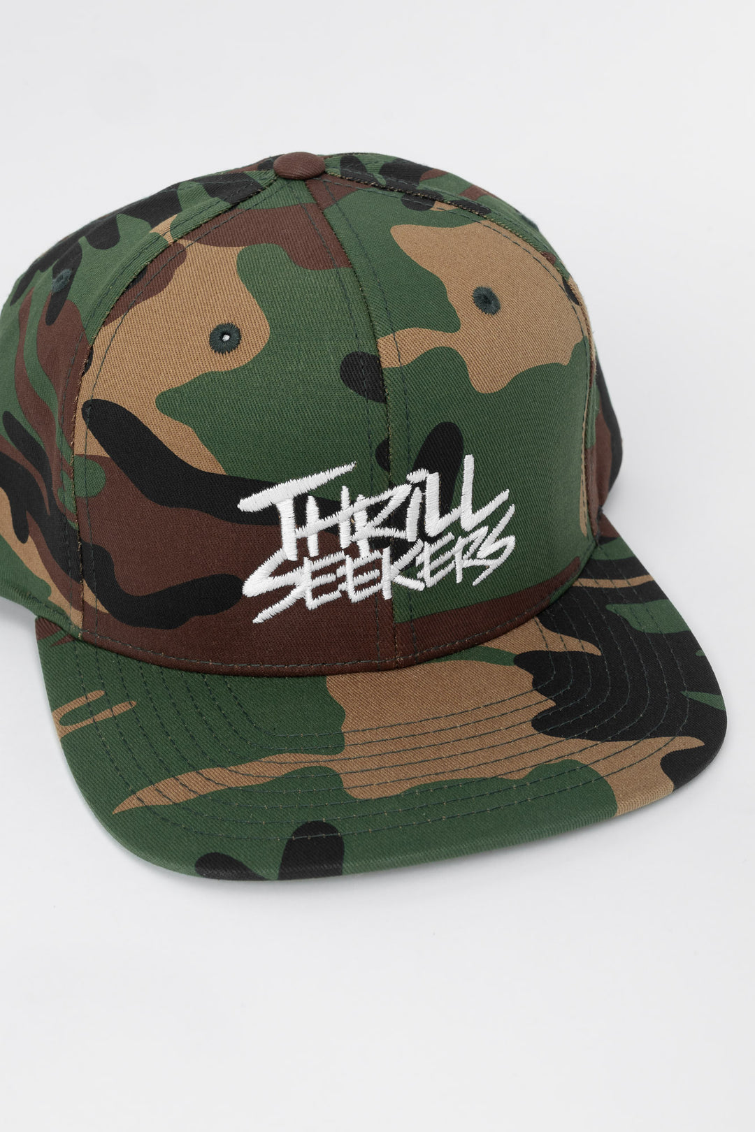Camo snapback hat with 'Thrill Seekers' logo in white