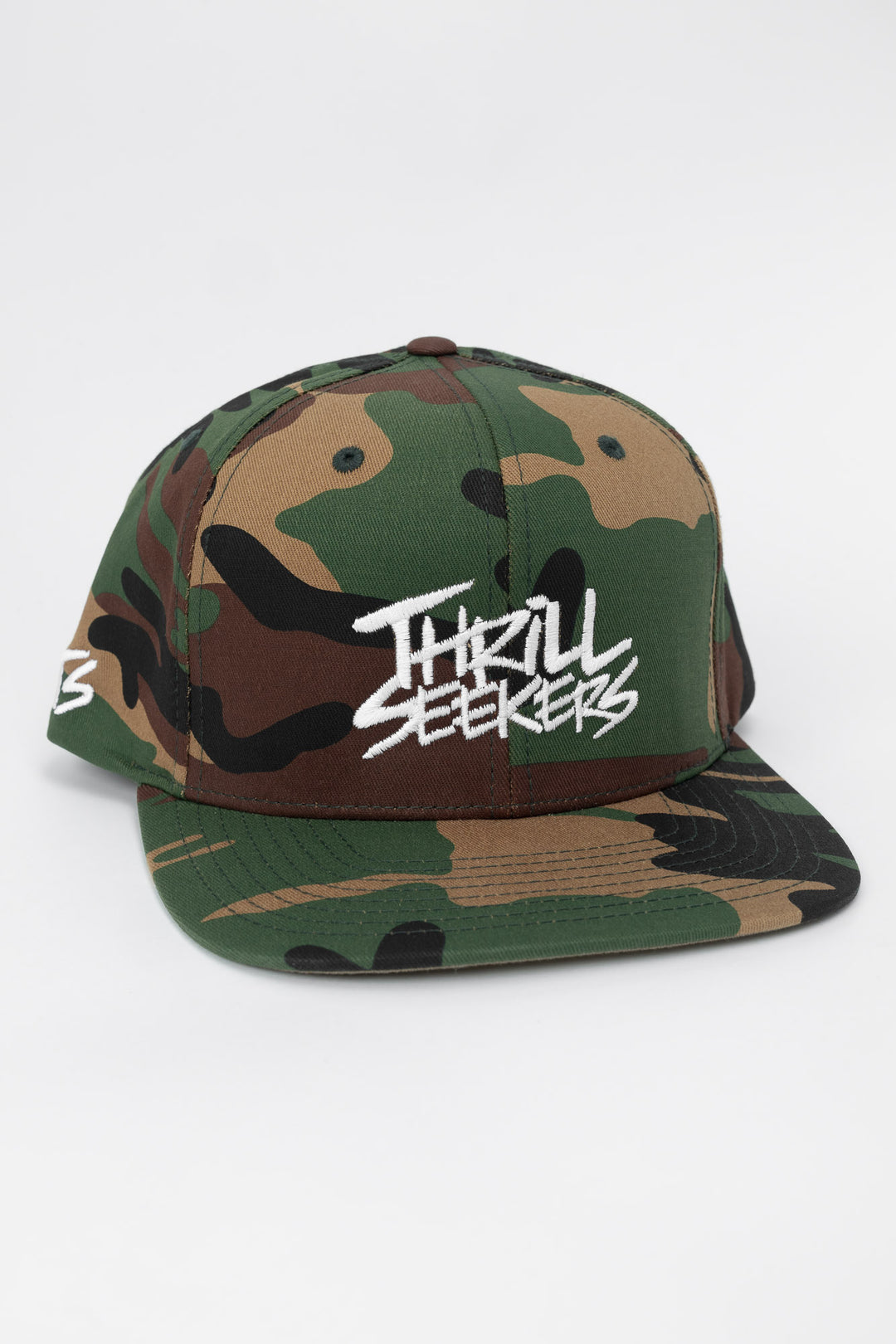 Camo snapback hat with 'Thrill Seekers' logo in white