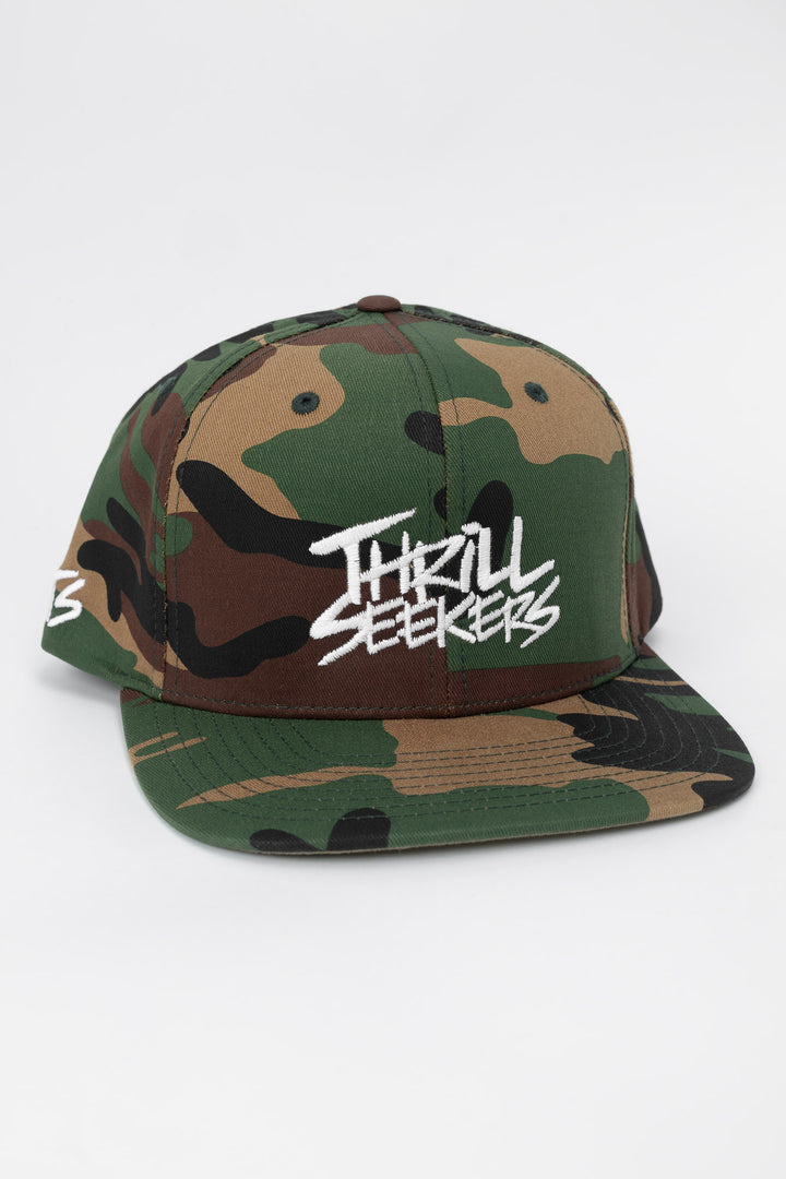 Camo snapback hat with 'Thrill Seekers' logo in white