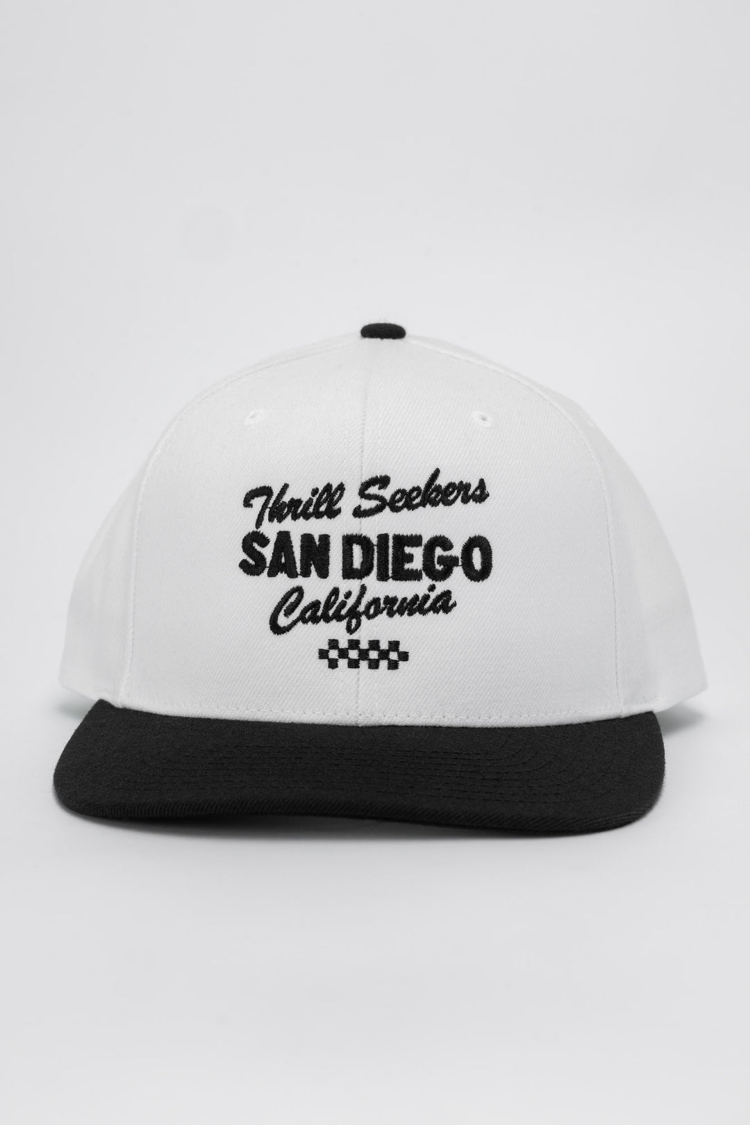 White and black snapback with 'Thrill Seekers' logo in black