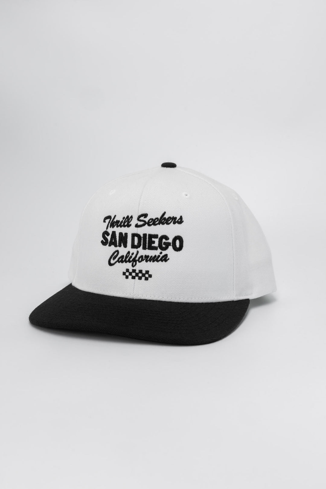 White and black snapback with 'Thrill Seekers' logo in black