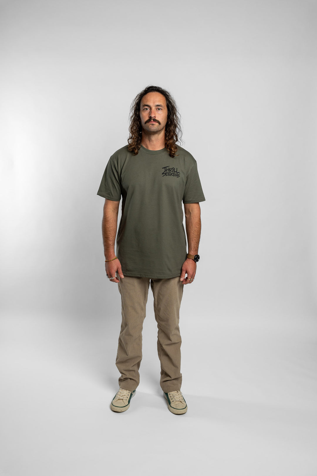 Person wearing a cypress tee with 'Thrill Seekers' logo in black