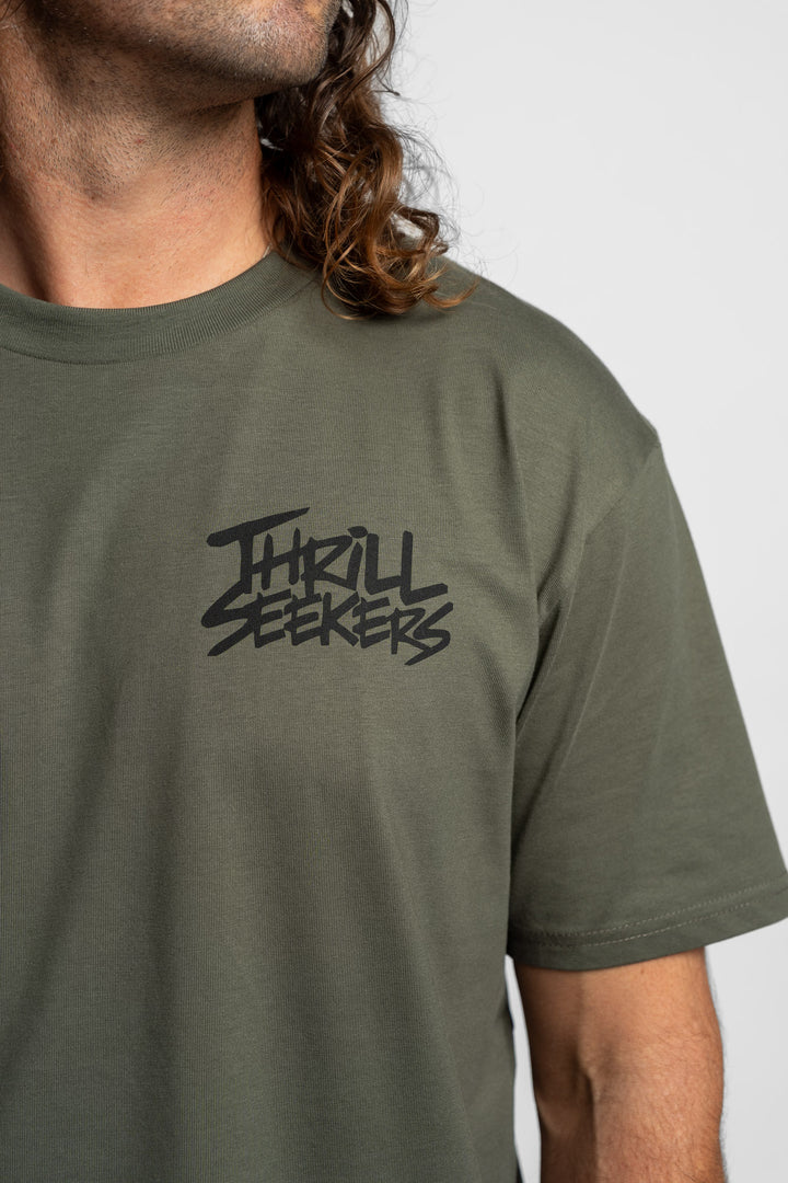 Person wearing a cypress tee with 'Thrill Seekers' logo in black
