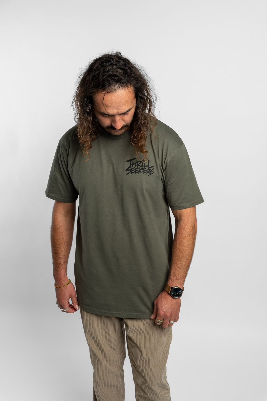 Person wearing a cypress tee with 'Thrill Seekers' logo in black