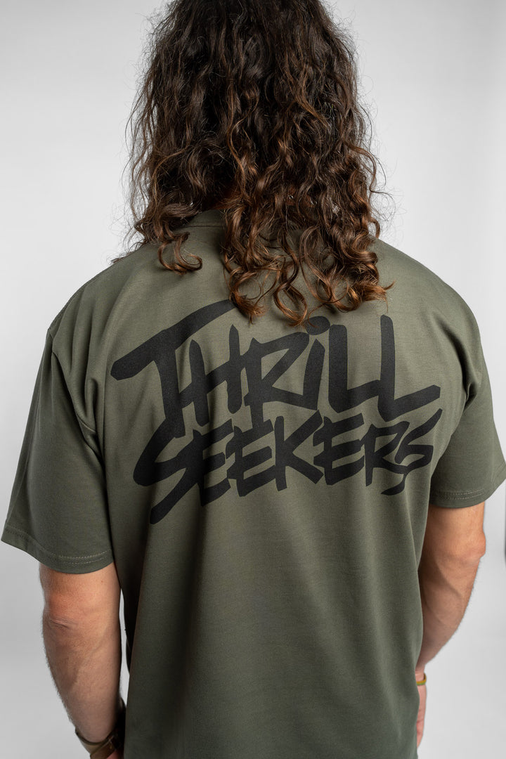 Person wearing a cypress tee with 'Thrill Seekers' logo in black