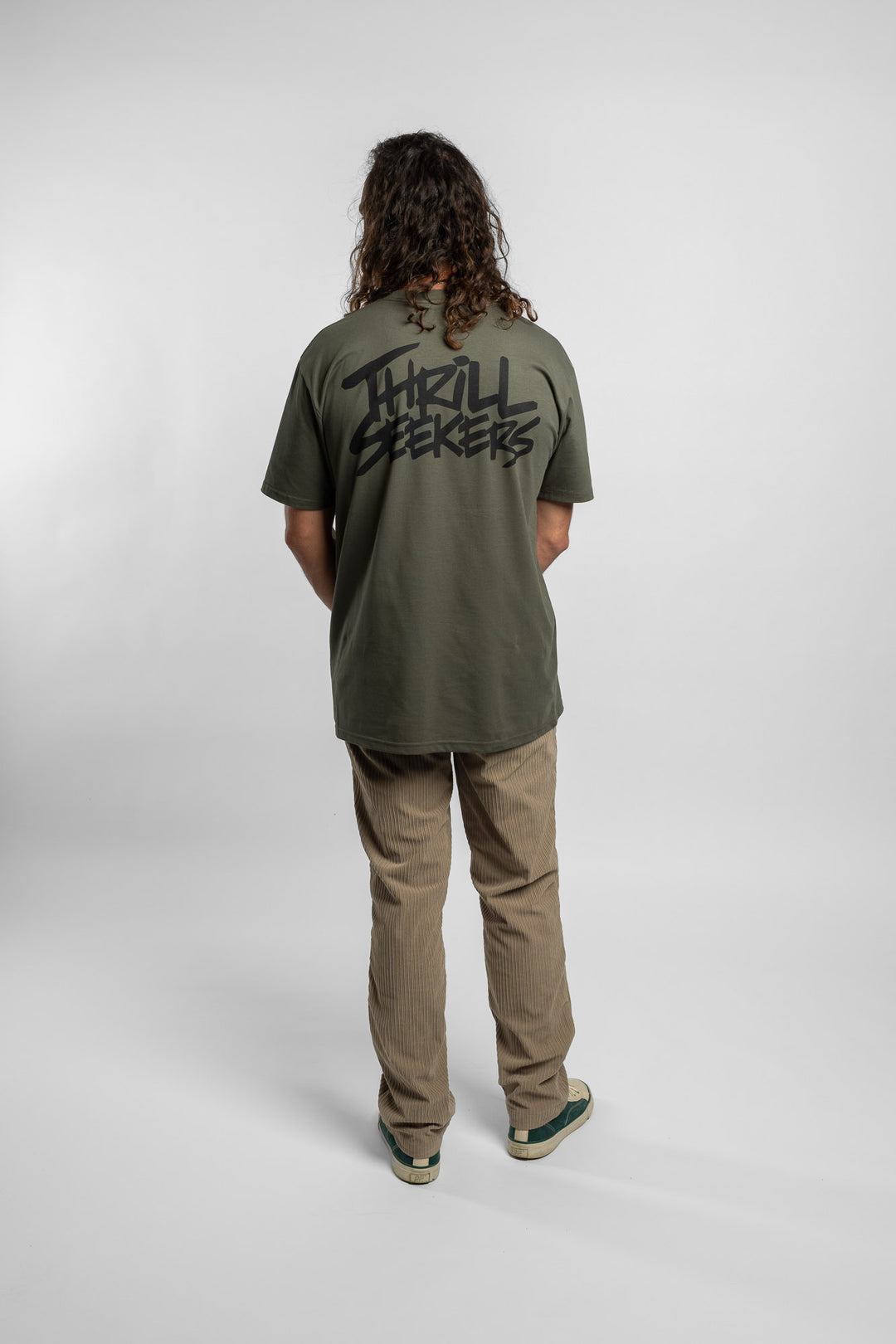 Person wearing a cypress tee with 'Thrill Seekers' logo in black
