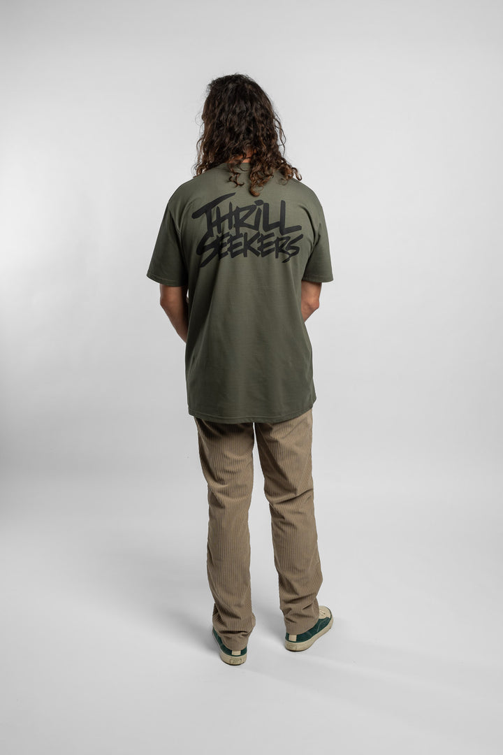 Person wearing a cypress tee with 'Thrill Seekers' logo in black