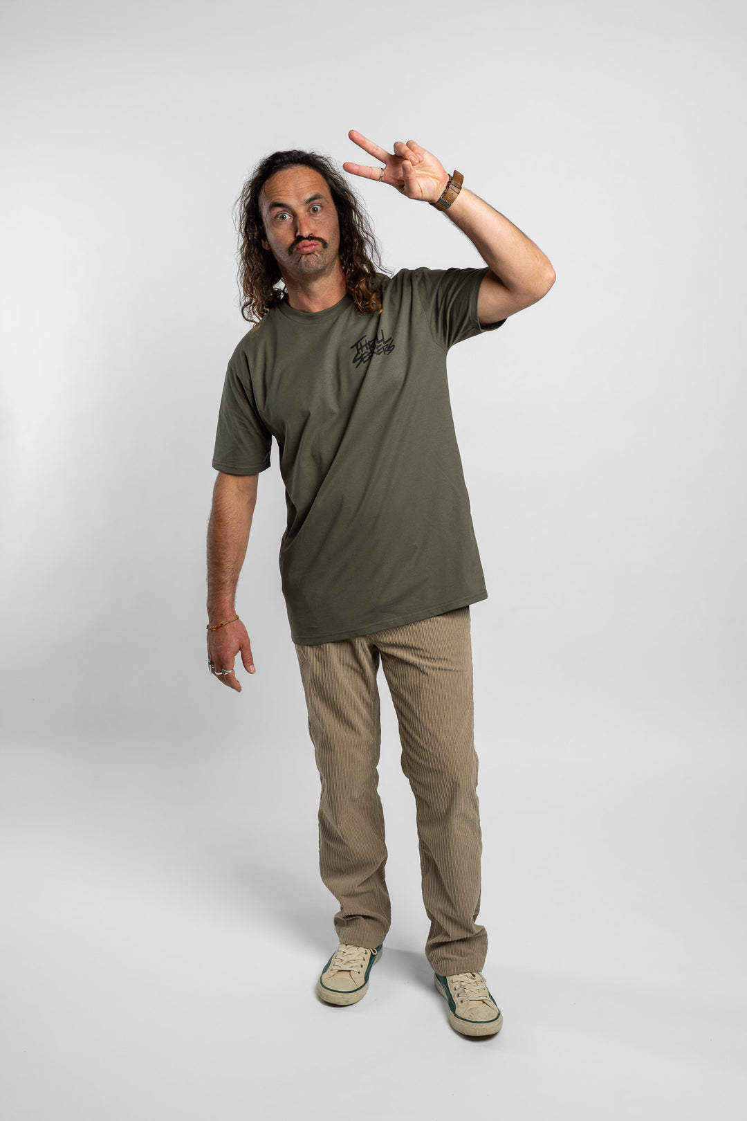 Person wearing a cypress tee with 'Thrill Seekers' logo in black