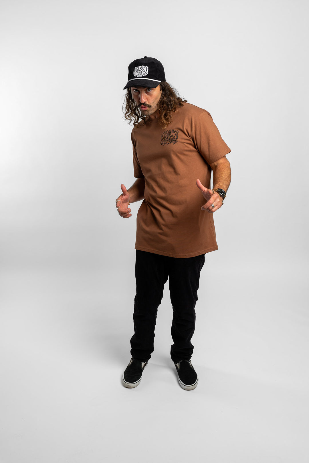 Person wearing cocoa tee with 'Thrill Seekers' scribe logo