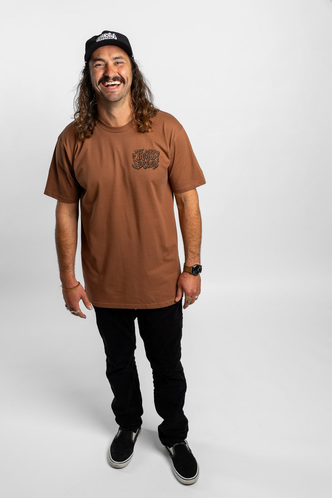 Person wearing cocoa tee with 'Thrill Seekers' scribe logo