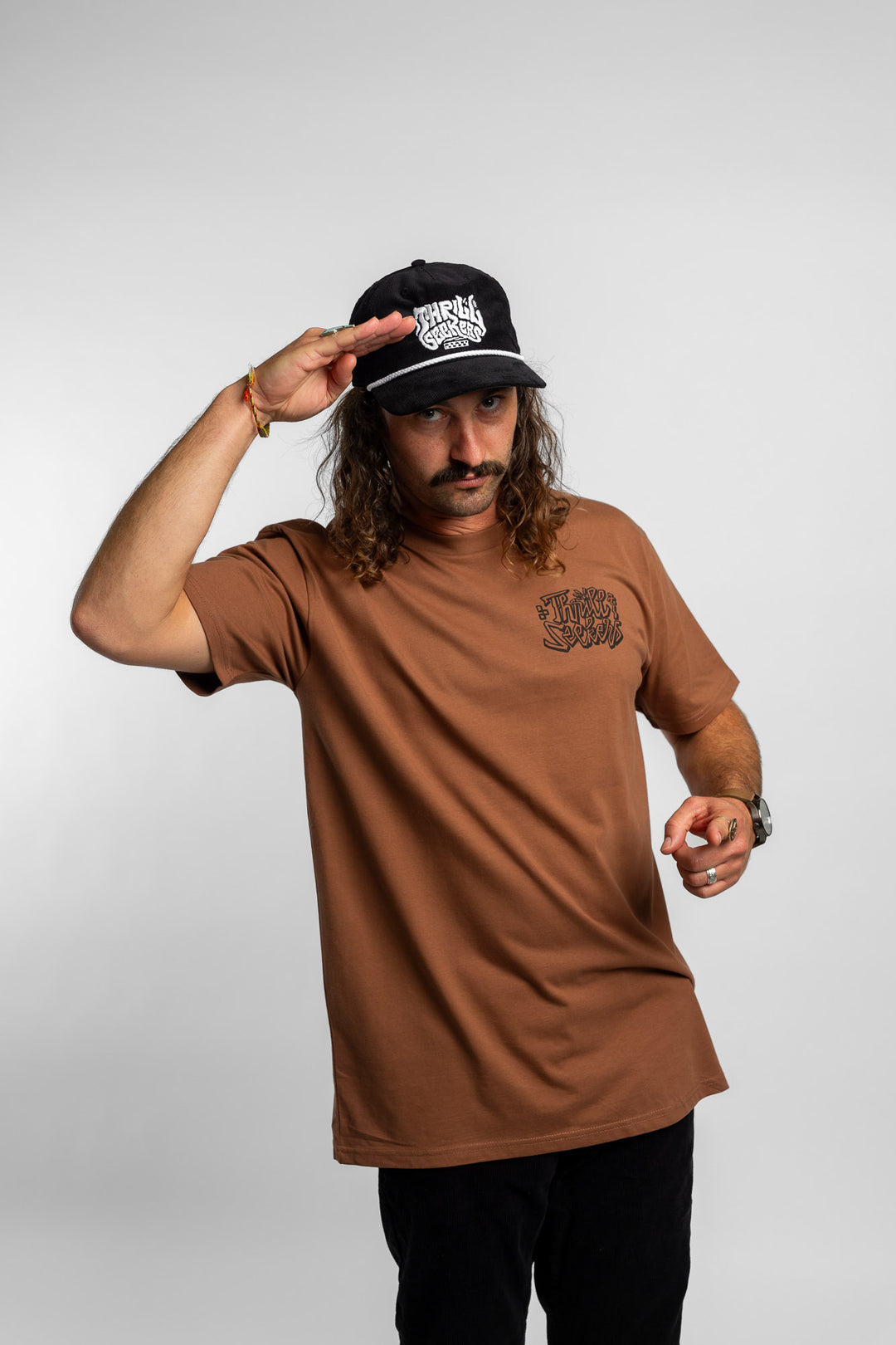 Person wearing cocoa tee with 'Thrill Seekers' scribe logo