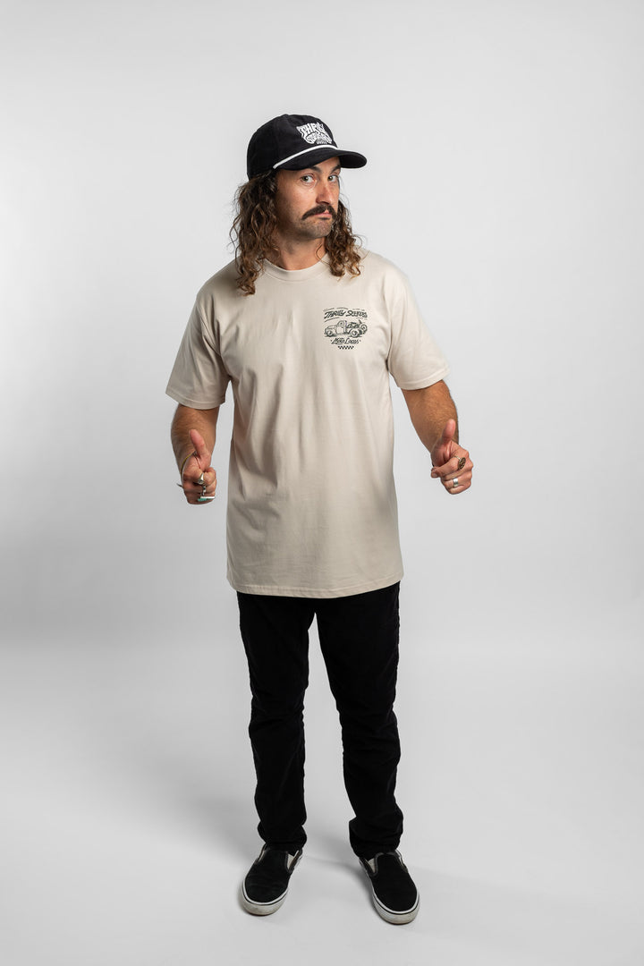 Person wearing bone tee with 'Thrill Seekers' moto locos logo in green