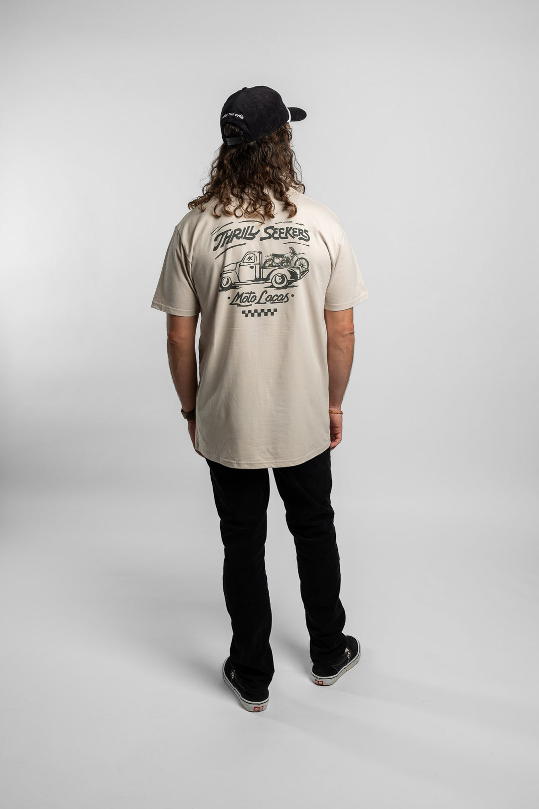 Person wearing bone tee with 'Thrill Seekers' moto locos logo in green